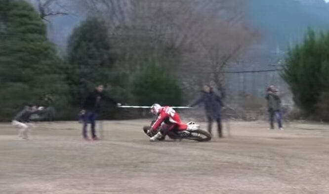 Video: How low can you go with motorcycle limbo?