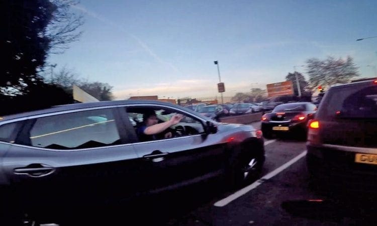 Video: Biker gets pelted with SWEETS by irate car driver caught on his phone by biker’s helmet camera